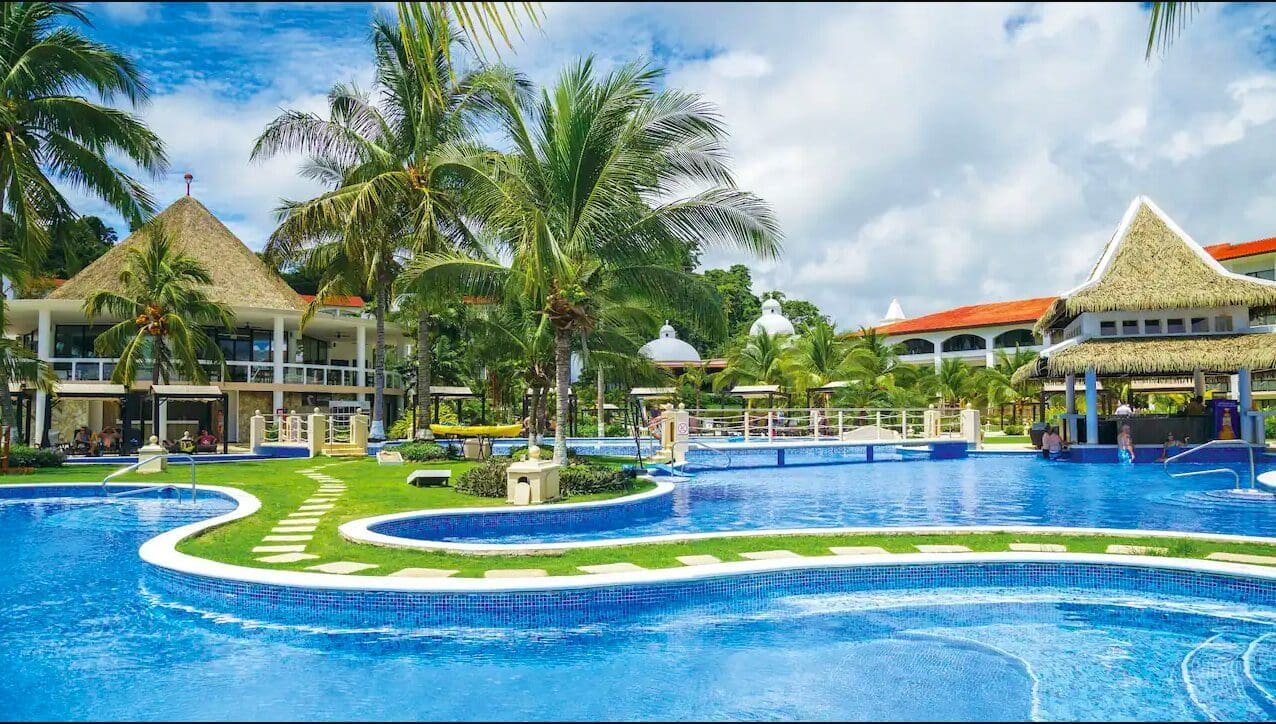 Tropical resort pool with palm trees